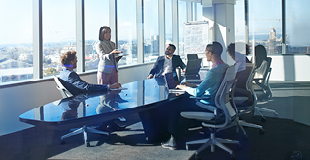 Business meeting with group on upper floor of sky scrapper.
